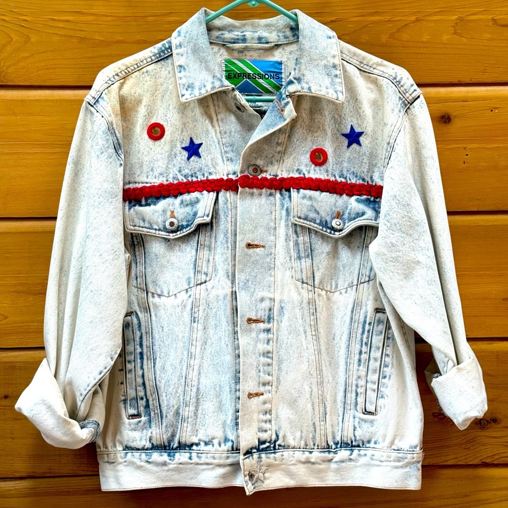 Vintage denim jacket hand-embellished with patriotic patches and trim.  Size M